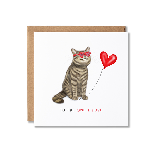 Greeting card with illustration of a tabby cat sat grinning with red heart glasses on holding a red heart ballon the message To The One I Love.