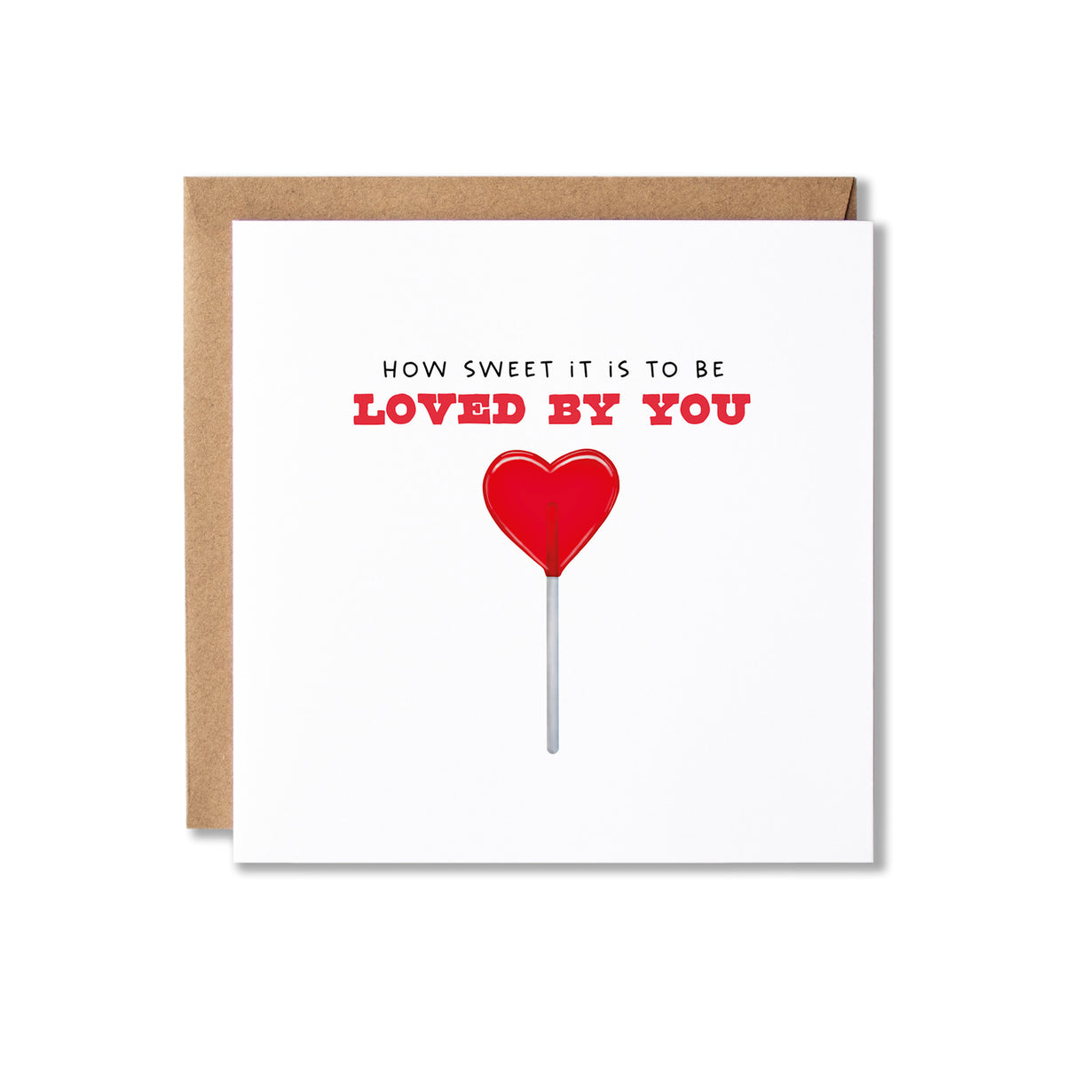 A square white greeting card with a kraft brown envelope behind it, featuring the text 'HOW SWEET IT IS TO BE LOVED BY YOU' in black and red above a red heart-shaped lollipop illustration.