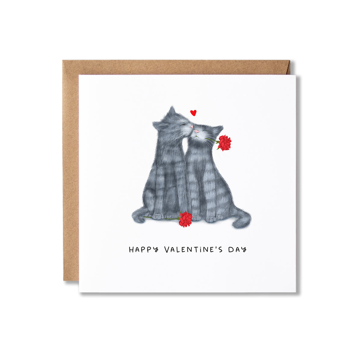 A square Valentine's Day greeting card with a white front featuring an illustration of two grey cats facing each other with red flowers and a small red heart above them with Happy Valentine's Day written underneath. The card is shown with a brown kraft envelope behind it on a white background.
