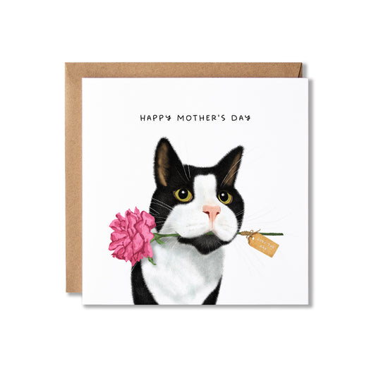 A Mother's Day greeting card with a white front featuring an illustrated black-and-white cat holding a pink flower, shown with a brown kraft envelope behind it on a light gray background.