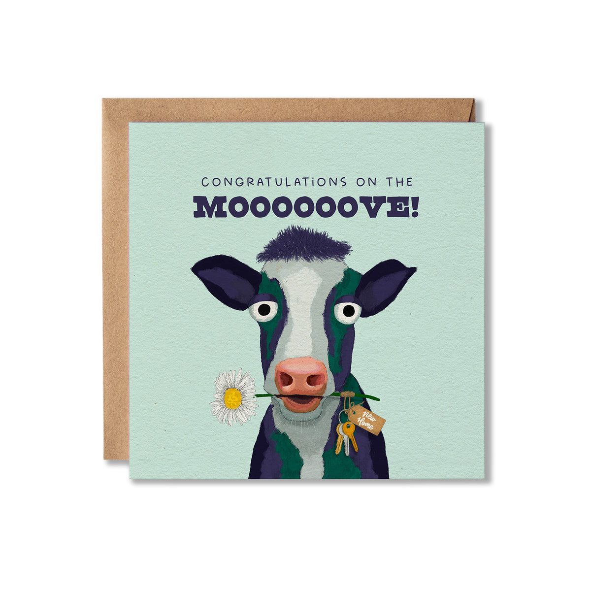 A square congratulations card with a kraft envelope behind it. The card has a pale mint background and features an illustrated cow with dark purple and white coloring, holding a daisy with a bunch of keys on the end with a New Home tag. The text 'CONGRATULATIONS ON THE MOOOOOVE!' above it.