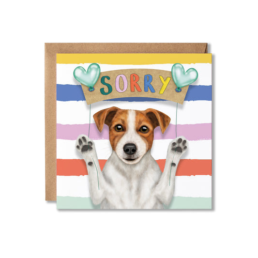 A square greeting card with a kraft envelope behind it, featuring an illustration of a white and brown dog with paws raised, under a sign that says 'SORRY' with two mint green hearts. The card has pastel horizontal stripes in blue, pink, orange, and mint green.