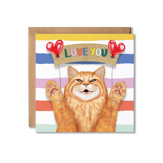 A square greeting card with a brown kraft envelope behind it. The card features an orange tabby cat with paws raised, holding a banner that says 'LOVE YOU' under two red heart balloons.