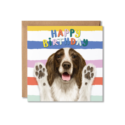 Birthday card with a Spaniel dog and colorful 'Happy Birthday' text on a striped background