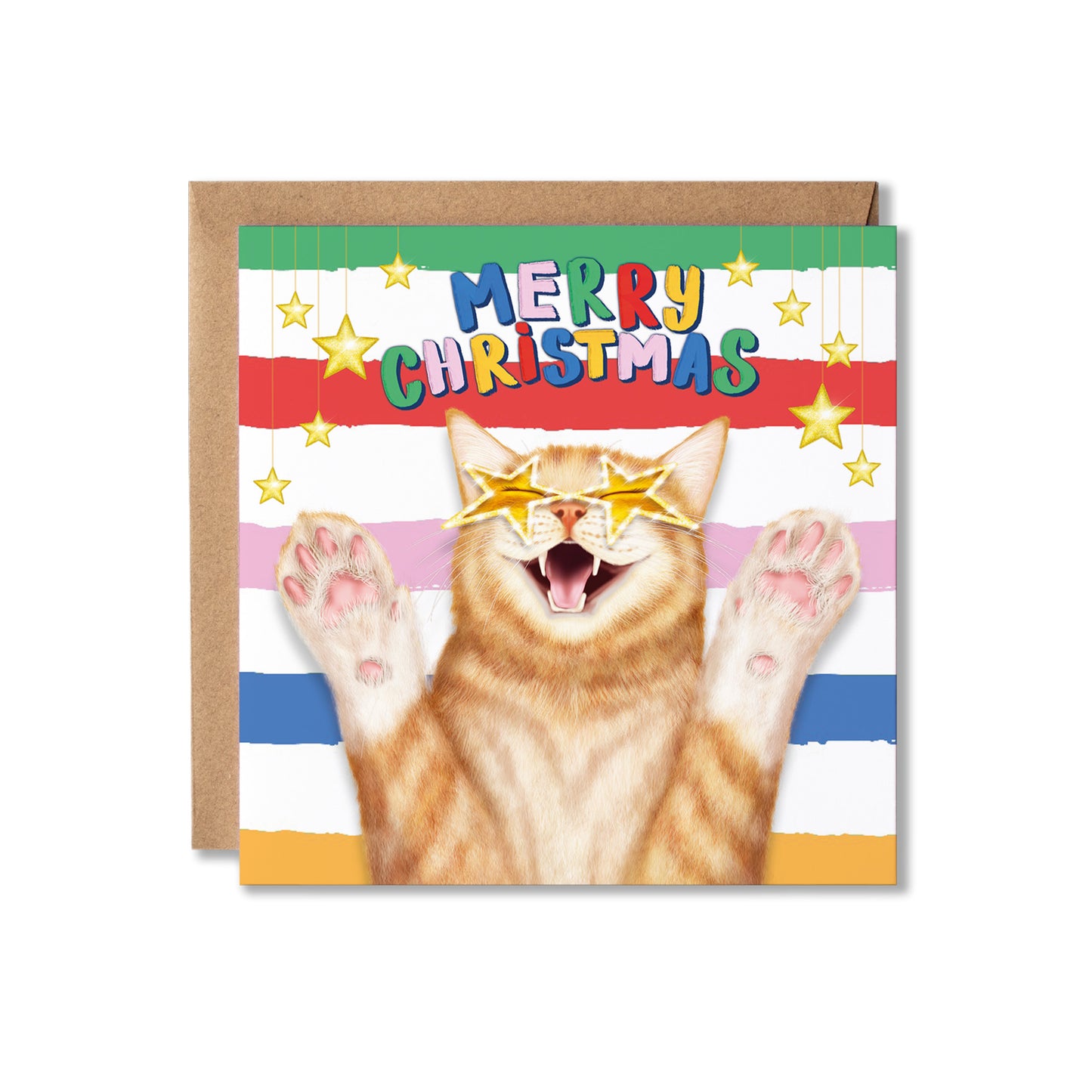 A Christmas greeting card featuring a ginger cat with star-shaped sunglasses and raised paws, with 'MERRY CHRISTMAS' in colourful letters above. The card is shown with a brown kraft envelope behind it on a white background.