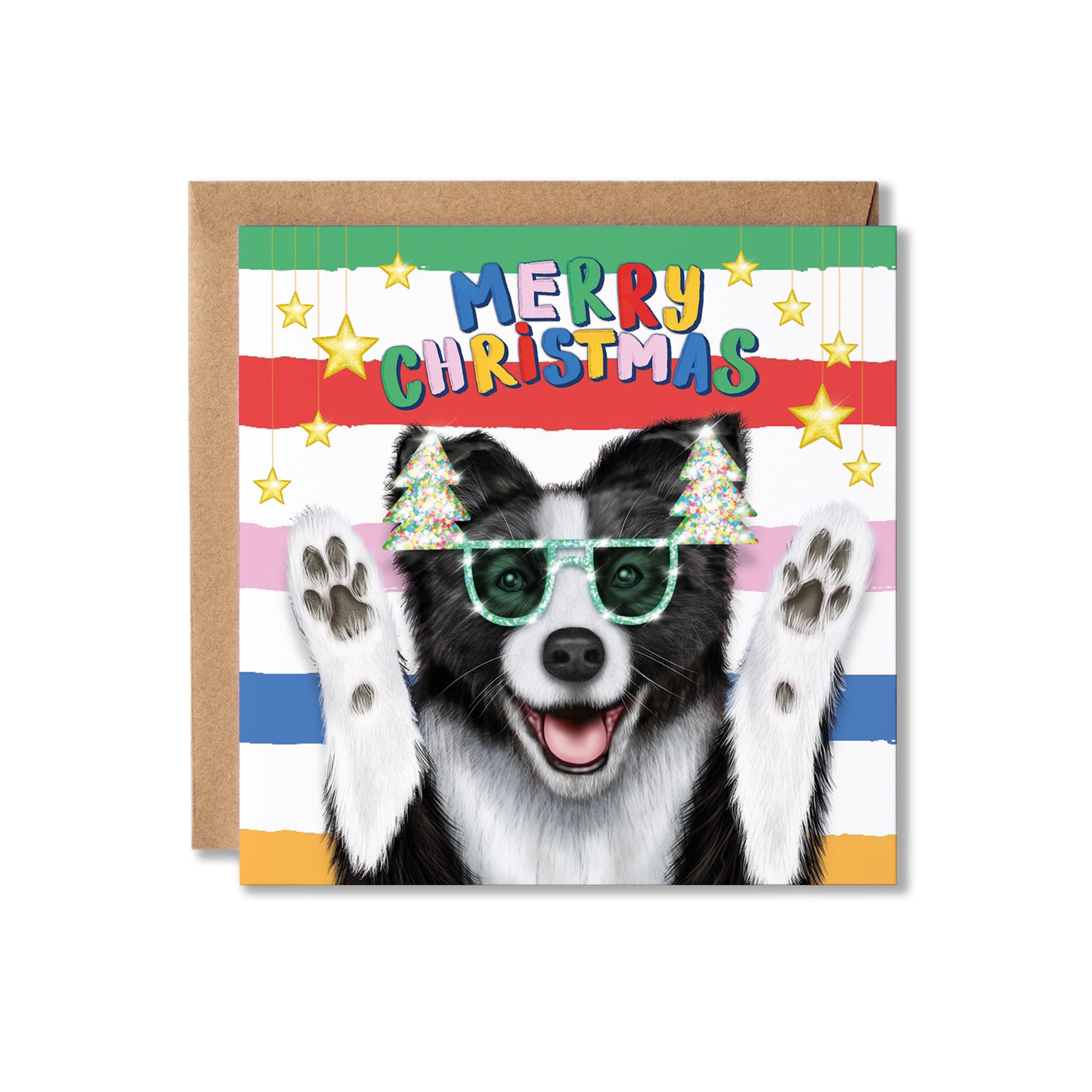 A square Christmas greeting card featuring a black and white dog wearing green sunglasses and small Christmas trees on its ears, with colorful striped bands and the words 'MERRY CHRISTMAS' at the top. A brown kraft envelope is placed behind the card on a white background.