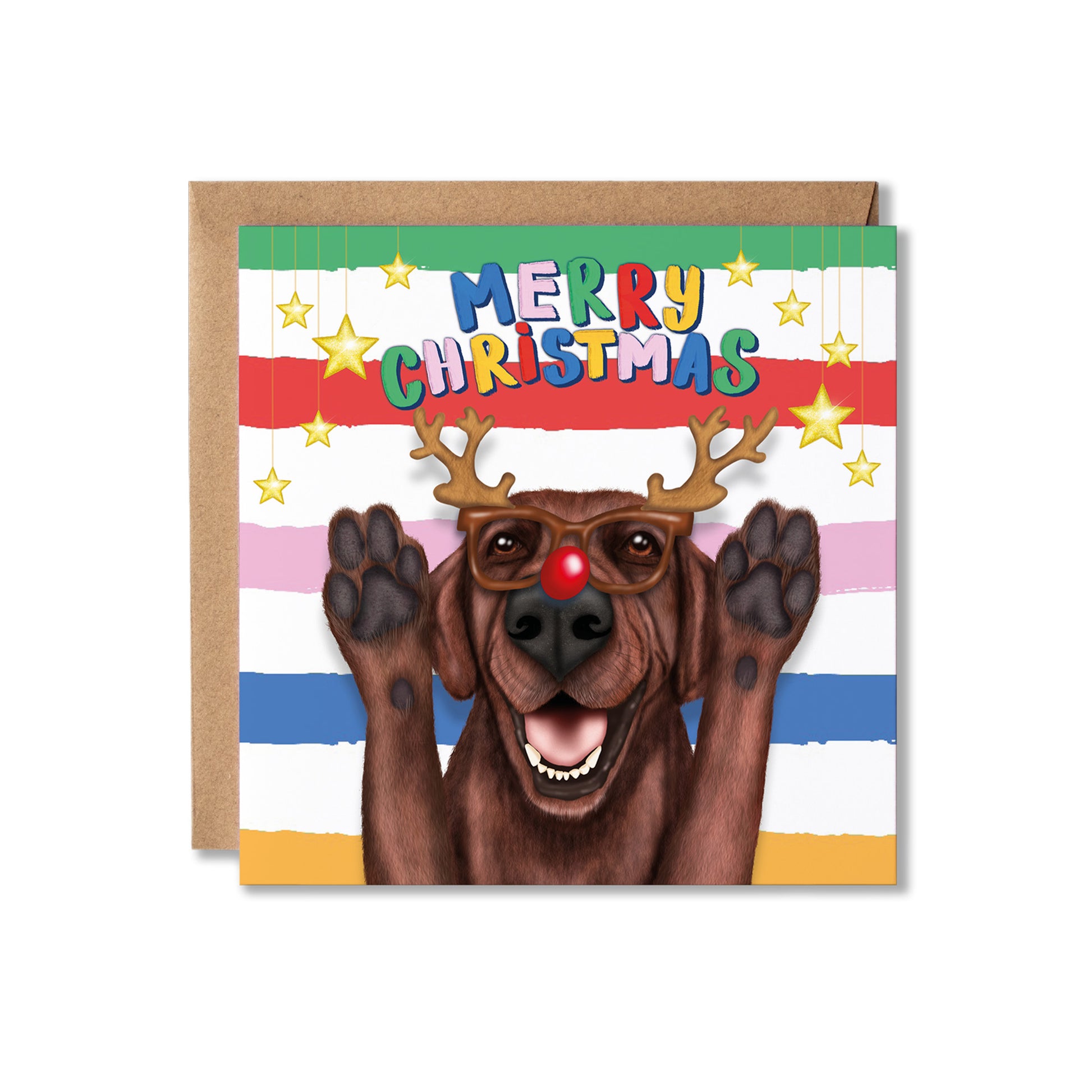 A square Christmas greeting card featuring a brown Labrador dog dressed as a reindeer with antler and red nose glasses and raised paws, with the text 'MERRY CHRISTMAS' above. The card is shown with a brown kraft envelope.