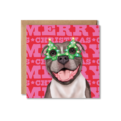 A Staffordshire Bull Terrier dog in a Christmas tree glasses with a colourful Merry Christmas background