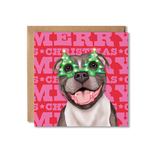 A Staffordshire Bull Terrier dog in a Christmas tree glasses with a colourful Merry Christmas background