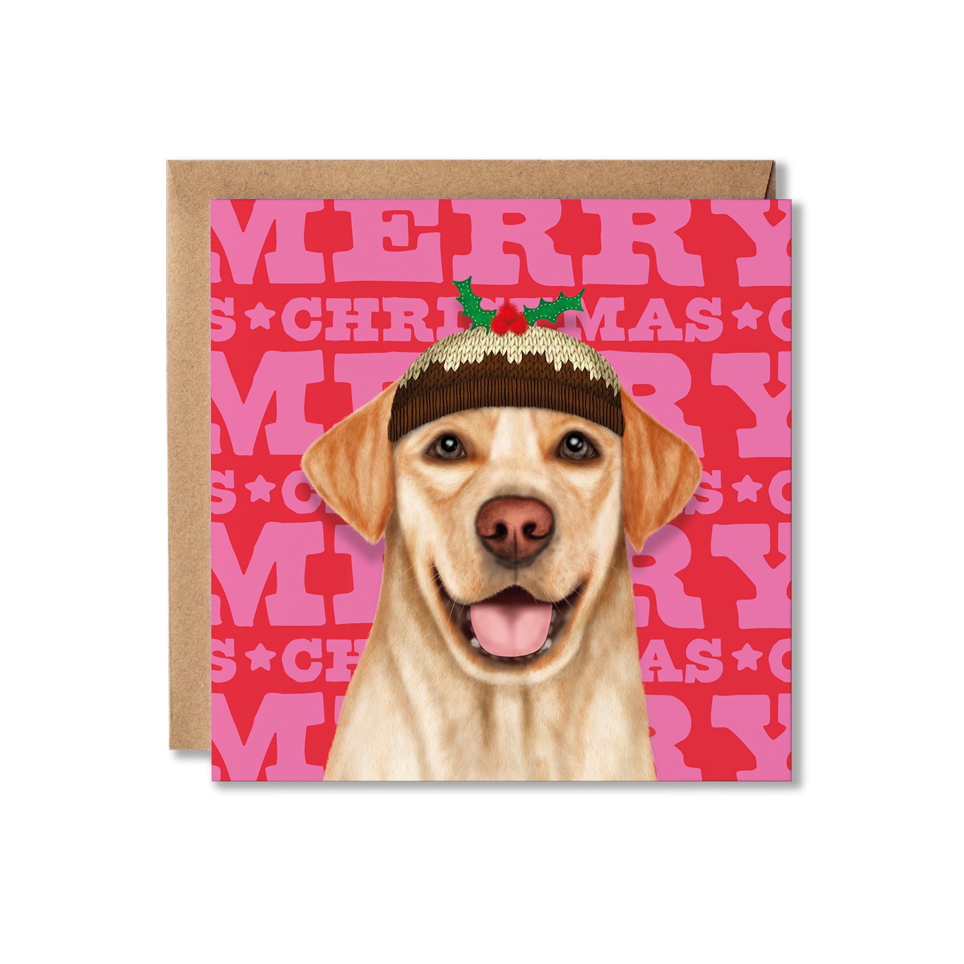 A square Christmas greeting card featuring an illustration of a yellow Labrador retriever wearing a brown knit Santa hat with green holly leaves, set against a pink and red background with repeating 'MERRY CHRISTMAS' text. A brown kraft envelope is placed behind the card on a white background.