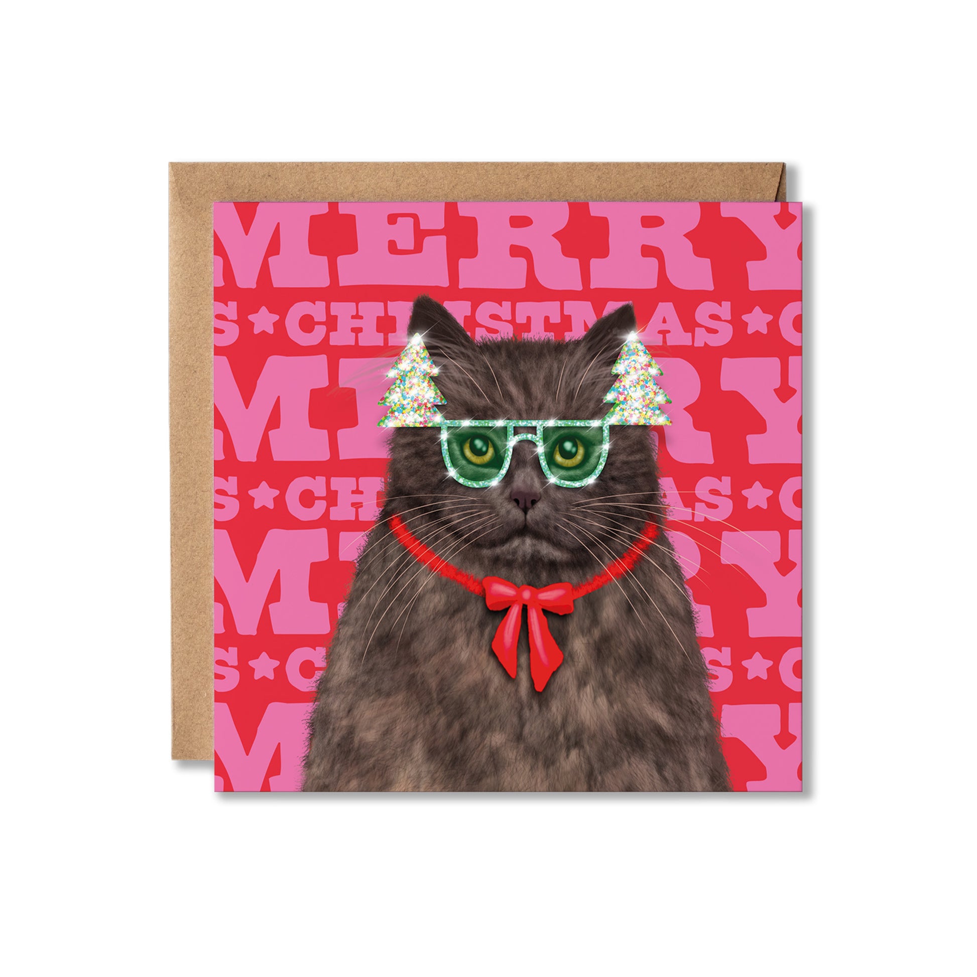 A square Christmas greeting card featuring a gray cat wearing green novelty glasses, a red bow tie, and small tree-shaped headbands, set against a pink patterned background with the word 'MERRY' repeated. A kraft paper envelope is placed behind the card on a white background.