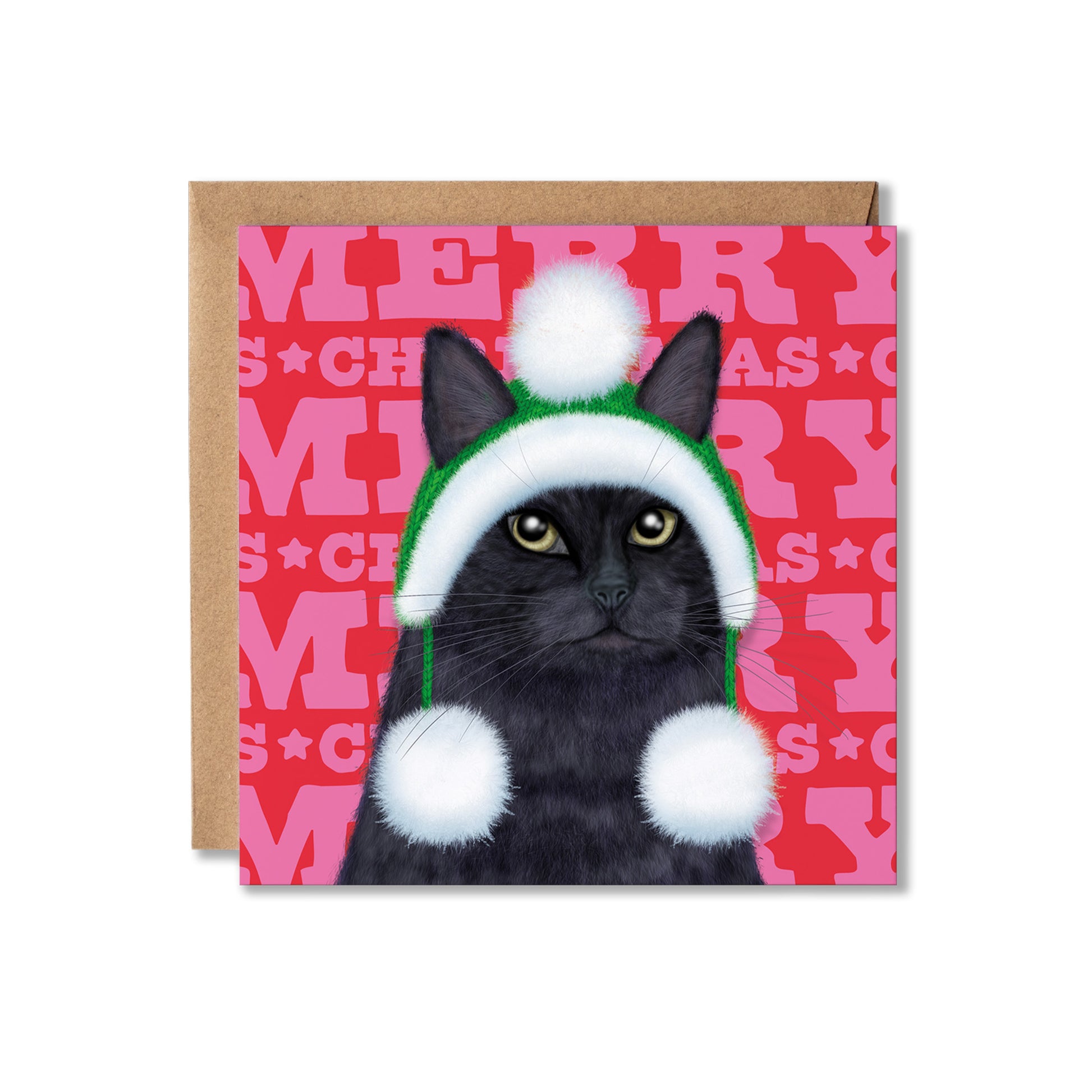 A square Christmas greeting card featuring a black cat wearing a green and white Santa hat with white pom-poms, set against a pink patterned background with the word 'MERRY' repeated. A brown kraft envelope is partially visible behind the card on a white background.