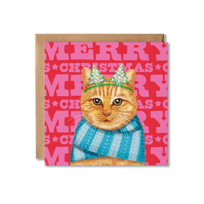 A ginger cat wearing a blue knitted scarf and Christmas tree headband with a colourful Merry Christmas background