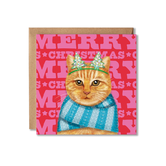 A ginger cat wearing a blue knitted scarf and Christmas tree headband with a colourful Merry Christmas background