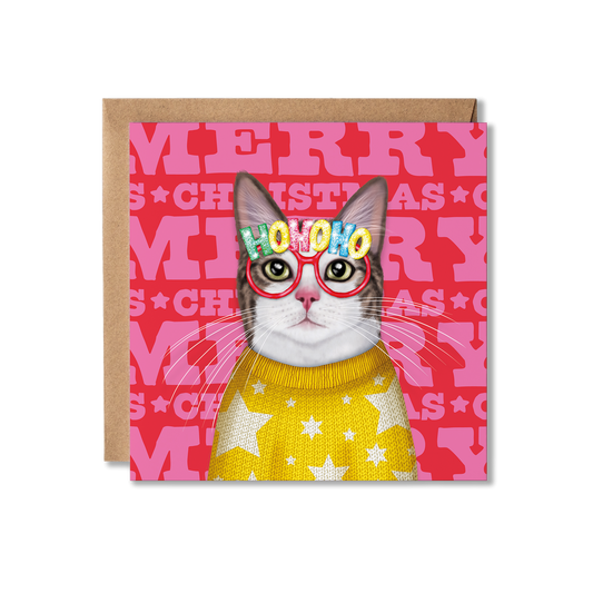 A white and grey cat wearing a yellow knitted star jumper and Ho Ho Ho glasses with a colourful Merry Christmas background